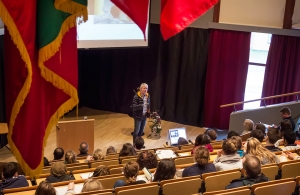 Cato speaking in the auditorium