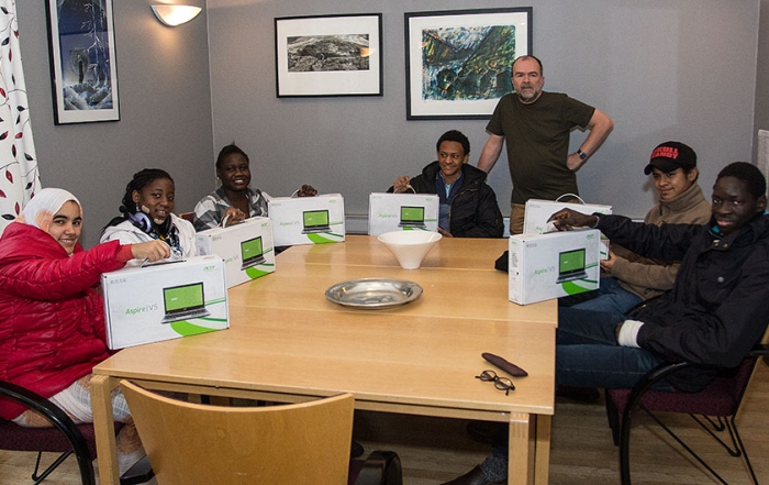 Thanks to our alumni! Here, students receiving laptops