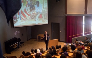 Sven Mollekleiv addressing staff, students and guests in the auditorium