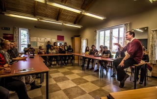 James Lamont speaking with students about the work of the journalist