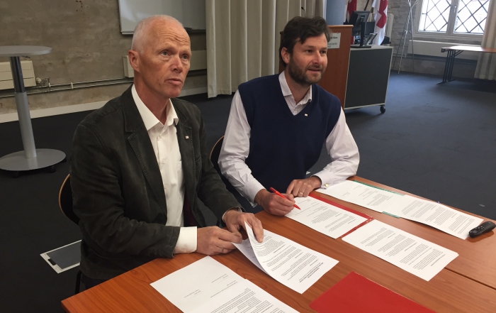 Robert Mood with Larry, signing the Agreement